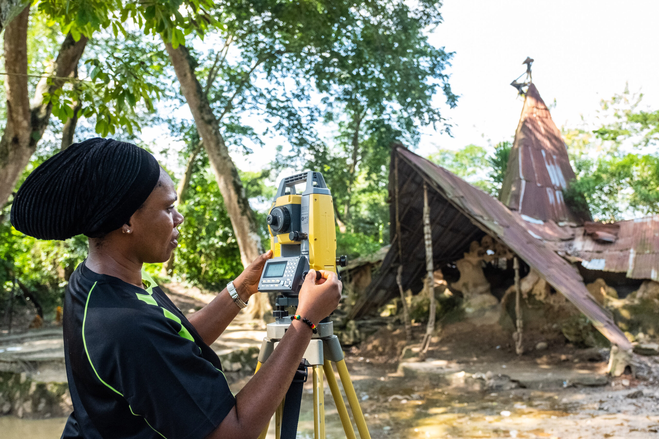 A staff of the National Commission for Museums and Monuments (NCMM), Dr. Ijeoma Harris using the total station at the Osun Osogbo Sacred Grove.